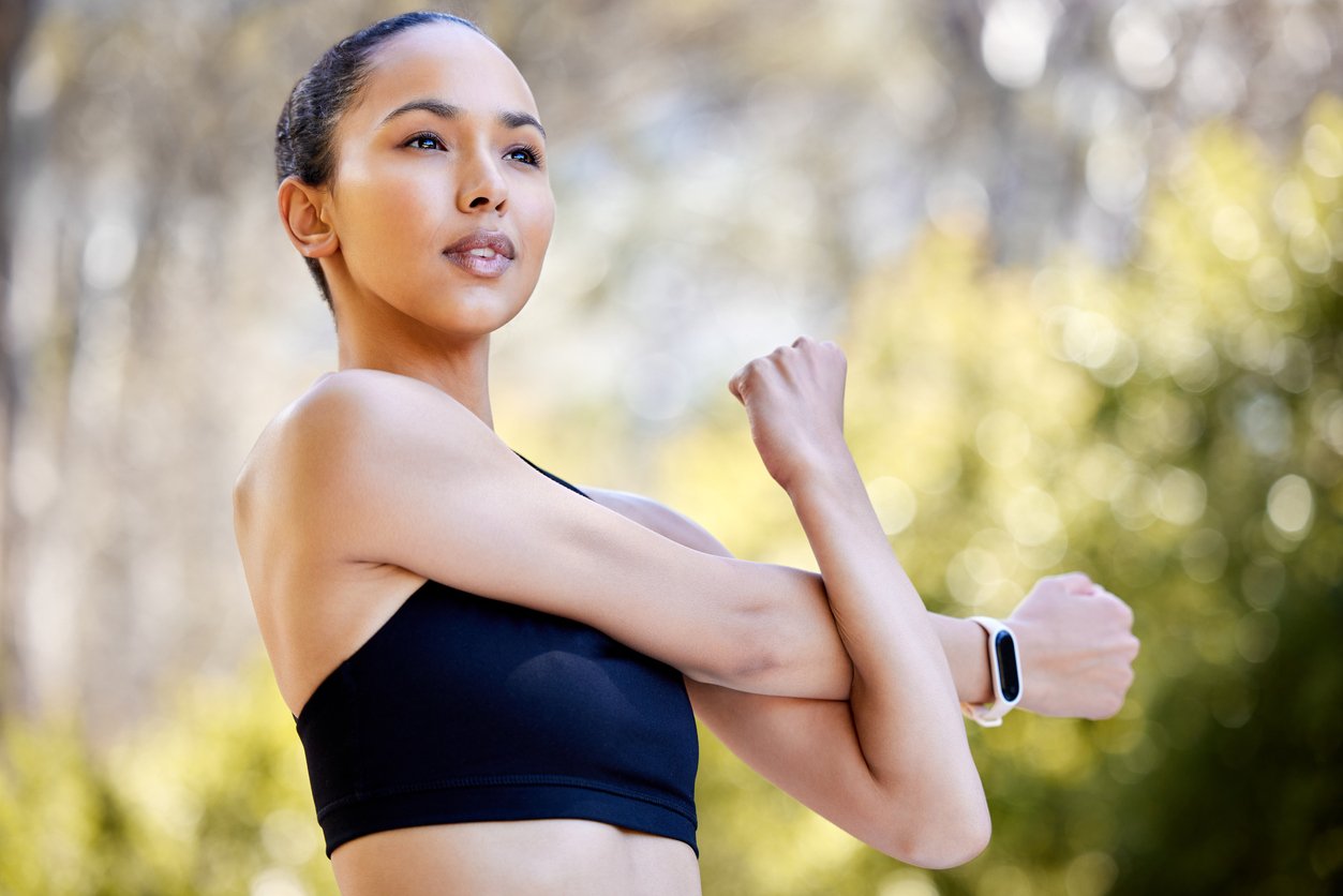 Woman stretching arms outdoors